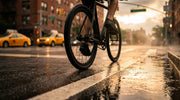 Tannus Airless tires on a commuter bike, riding down a New York City street at golden hour after a rainstorm.